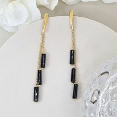 Introducing our stunning black onyx long drop dangle earrings with a fine gold chain. These earrings are the perfect accessory for any stylish woman who wants to make a bold statement. The deep black onyx gemstones add a touch of elegance and sophistication, while the long drop design adds a modern twist. The fine gold chain adds a touch of glamour, creating a beautiful contrast against the black onyx. Whether you're dressing up for a special occasion or adding a touch of sophistication to your Elegant Jewelry With Dangling Beads, Gold Plated Chandelier Dangle Earrings For Parties, Gold Plated Dangle Chandelier Earrings For Party, Gold Plated Chandelier Earrings For Party, Gold Plated Dangle Jewelry For Party, Elegant Formal Jewelry With Dangling Beads, Party Long Drop Linear Earrings Fine Jewelry, Elegant Linear Earrings With Dangling Beads For Party, Elegant Gold-plated Earrings With Dangling Beads