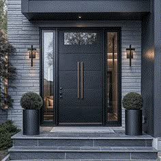 the front door of a modern house with two planters