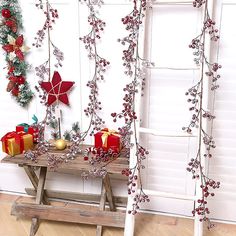 a wooden bench sitting next to a christmas tree with presents on it and decorations hanging from the branches