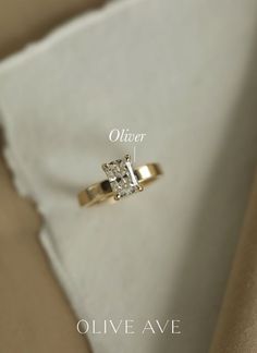 a diamond ring sitting on top of a white pillow