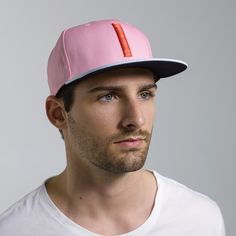 The Blinky is a classic six-panel, baseball-style cap in pink with a contrasting light blue brim and raised embroidery detail in orange. All March Caps feature top eyelets and an adjustable snap-back closure. Each cap comes with a hand-numbered card signed by the designer. Pink Flat Bill Sports Hat, Pink Flat Bill Snapback Hat For Sports, Pink Snapback Hat For Sports, Pink Fitted Hat With Flat Brim, Casual Pink Fitted Hat With Flat Brim, Pink Trucker Hat For Baseball Season With Curved Brim, Pink Casual Snapback Hat For Baseball Season, Casual Pink Snapback Hat For Baseball Season, Pink Snapback Hat For Spring Sports