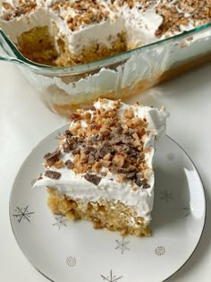 a piece of cake sitting on top of a white plate next to a glass casserole dish