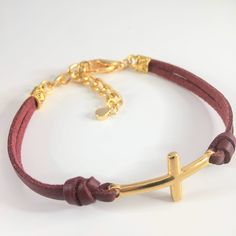 Leather Cross bracelet with adjustable extender chain and lobster claw closure. You may choose from 18 leather color options from the option menu as well as the adjustable size that fits best. Our current production time is 1-3 business days. All our jewelry and gifts are packaged in complimentary gift boxes and a personal note will be included upon request. Please feel free to message us with any question you may have. Thanks for stopping by & God Bless! Adjustable Leather Jewelry With Bracelet Strap, Adjustable Leather Jewelry With Adjustable Chain, Adjustable Gold Leather Bracelet, Adjustable Leather Jewelry, Adjustable Leather Jewelry For Everyday Wear, Adjustable Brown Bracelet With Lobster Clasp, Adjustable Brown Bracelets With Lobster Clasp, Adjustable Gold Jewelry With Leather Strap, Gold Jewelry With Adjustable Leather Strap