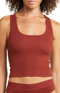 A tried-and-true classic, this scoop-neck tank that's made to layer with ribbed stretch cotton is from Kim Kardashian's highly sought-out SKIMS. Available in a wide range of colors, this comfortable style that hits right at the natural waist for a no-fuss, no-tuck fit is destined to be a part of your regular lounge rotation. 17" length (size Medium) Scoop neck 95% cotton, 5% spandex Hand wash, dry flat Imported Fitted Athleisure Top For Lounging, Cotton Ribbed Tank Top For Loungewear, Casual Seamless Tops For Lounging, Ribbed Cotton Tank Top For Loungewear, Everyday Cotton Tank Top With Ribbed Neckline, Solid Ribbed Tank Top For Loungewear, Fitted Tops With Ribbed Waistband For Loungewear, Casual Fitted Tops For Lounging, Fitted Tops With Ribbed Waistband