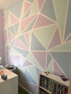 a room that has some kind of wall paper on the walls and is painted with pastel colors