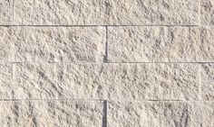 a close up view of a wall made of concrete blocks, with small cracks in the middle