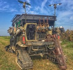 an old jeep with birds on the roof and leather bags hanging from it's windows