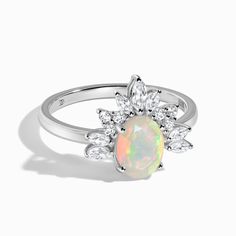 About This Ring
Part of our new Luxe Collection, this genuine Opal ring dazzles next to a row of nine White Topaz stones. Taking notes from the crown jewels of Europe, Manon radiates beauty and poise.      Details
- Authentic Moon Magic Opal- Premium, gift-worthy ring box - Stone Size: 0.24" x 0.31" (6mm x 8mm)- Cut: Oval-shaped brilliant-cut Opal & marquise + round-shaped brilliant-cut White Topaz- Gem authenticity approved by GIA The Crown Jewels, Gem Diamonds, White Topaz Rings, Taking Notes, Rose Quartz Ring, Opal White, Moon Magic, Zircon Ring, Topaz Stone