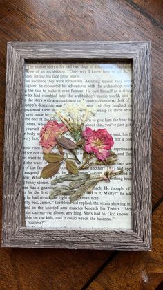 an old book with some flowers in it