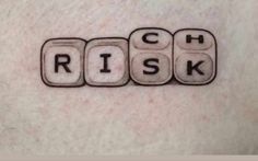 the word'rich'is spelled by scrabble blocks in black and white