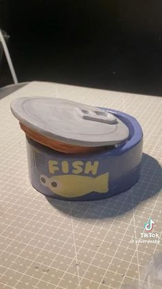 an empty can of fish on a cutting board