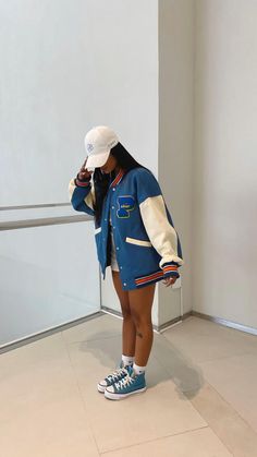 Nba Jacket Outfit, Syracuse Dunk High Outfit, Varsity Style Outfits, Varsity Jacket Outfit Shorts, Ny Rangers Outfit Women, Becky G Outfits Casual Street Styles, Basketball Jacket Outfit Women, Casual Sporting Event Outfit, Oversized Letterman Jacket Outfit