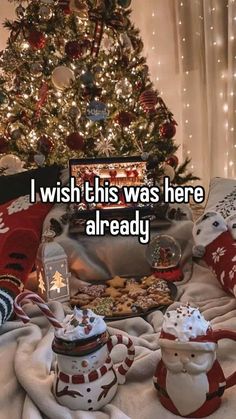 two teapots sitting on top of a blanket next to a christmas tree with the words i wish this was here already