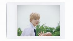 a young man in a white shirt and tie holding a basketball