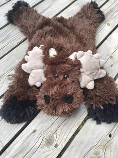 a stuffed animal laying on top of a wooden floor