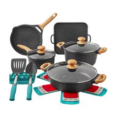 an assortment of pots and pans with spatulas on the bottom, next to each other