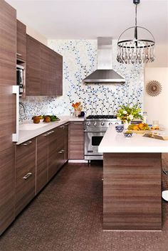 a modern kitchen with wood cabinets and white counter tops, an island in the middle