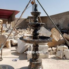 an old fashioned water fountain in the middle of rubble