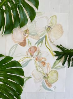 an arrangement of tropical leaves and flowers on a white background with a painting of orchids