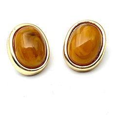 "Beutiful Vintage oval cabochoon Tigere's Eye clip on earrings. These gold tone base earrings have a beautiful orange tone cabochon Tigers eye stone. These are part of my mother in laws estate from the 60's. Very glam and perfect for any occassion. The clip on earrings are in good vintage condition, please reeference images and ask any questions you may have. The Oval Cabochon Tiger's Eye Clip on earrings measure 1\" by 3/4\" PLEASE NOTE THE FLORAL IN THE IMAGE IN THE BACKGROUND IS NOT INCLUDED Holly Images, Tigers Eye Stone, Picture Frame Ornaments, Orange Tone, Ornament Frame, In Laws, Tiger Eye Stone, Eye Stone, Vintage Clip