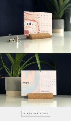 a desk with a plant and calendar on it