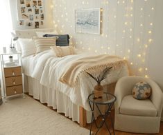 a bedroom with lights on the wall and a white bed in front of a window