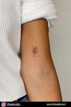 a woman's arm with a small tattoo on the left side of her body