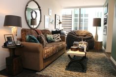 a living room filled with furniture and a large mirror