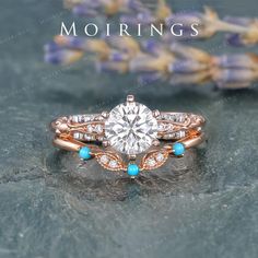 a close up of a ring on a table with flowers in the background and text mohriings