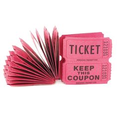 a pink ticket sitting on top of a book with the words keep this coupon printed on it