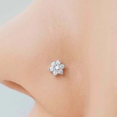 the back of a woman's breast with three small diamonds on top of it