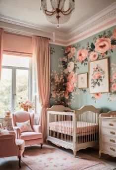 a baby's room decorated in pink and blue with flowers on the wall, crib, rocking chair, dresser and chandelier