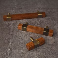 two pieces of wood and brass on the ground