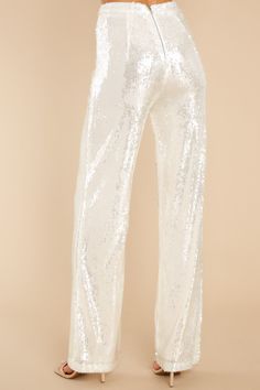 Put your dancing shoes on and this sruning white sequin pair of pants on to your next party. Dance the night away looking like a stunner. These pants feature a straight leg flowy style. zipper down the back with a hook and eye closure. and have a high waist fit. Model is wearing a size small. • 60% Pet. 40% Polyester • Hand Wash Cold • Lined 95% Polyester. 5% Spandex • Imported Sorority Rush Dresses, Flowy Style, Rush Dresses, Sequin Pants, Cardigan Crop Top, Outfits Petite, Dancing Shoes, Party Dance, Current Fashion