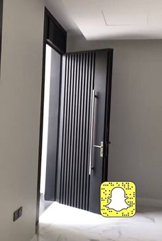 an open door with the snap icon on it in front of a white wall and floor