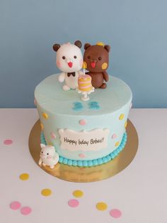 there is a birthday cake with two bears on it