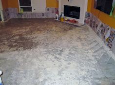 a living room that is being remodeled with carpeting on the floor and tile around the fireplace