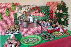 a table topped with lots of christmas treats and desserts on top of green plates