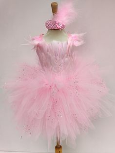 a mannequin with pink feathers and a tiara