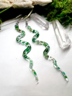 Handmade Emerald Resin Snake Earrings ◇Nickel Free ◇ ◇ Lightweight and Large Impact ◇ ◇ Uniquely Handmade to Order ~ Feel Free to ask questions or make requests prior to purchasing ◇ ▪CARE INSTRUCTIONS▪ Store in a clean dry area.  Do not wear in water. Please treat your handmade jewelry kindly. If dropped or bent, they may break. Please consider no two will be the exact same as every piece is handcrafted by me and our beautiful Mother Nature. I will ensure your piece is as gorgeous as these orig Green Wire Wrapped Crystal Earrings As Gift, Handmade Green Plug Earrings As Gift, Green Wire Wrapped Crystal Earrings For Gift, Handmade Snake-shaped Earrings As Gift, Resin Snake Earrings, Snake Statement Earrings, Handmade Snake-shaped Bohemian Jewelry, Handmade Gold Snake-shaped Earrings, Raw Emerald