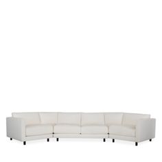 a white sectional couch with black legs on a white background, it's facing the camera