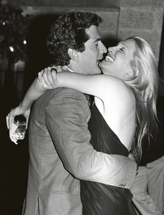 a man and woman embracing each other at a party