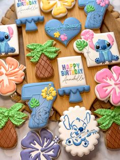 decorated cookies are arranged on a wooden platter