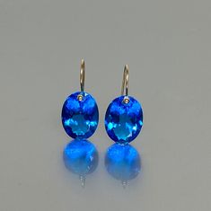 Gorgeous sparkly swiss blue Topaz earrings. The Faceted ovals are flawless and eye clean and have a beautiful vivid clear bright blue color. The earrings are elegant, minimalist, and have a lux look. A truly gorgeous pair of earrings. When 14K SOLID GOLD ear wires are being used, the ear wire ends are hand-stamped as proof of being 14K solid gold. In addition, extra work was done at the end of the ear wires to prevent any sort of pain or injury while inserting them through the ear lobes. **The 1 Luxury Oval Blue Topaz Earrings, Modern Oval Blue Earrings, Modern Blue Oval Earrings, Blue Topaz Oval Earrings, Small Drop Earrings, Extra Work, Oval Earrings, Topaz Jewelry, Blue Topaz Earrings