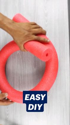 a person is holding an easy diy toy in front of a white wall with the words easy diy written on it