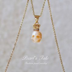 Product details: Pearl: Natural Pearl Necklace: Silver, gold filled, solid gold What's in the box: An unique cool pearl skull necklace A beautiful earring box A professional jewelry polishing cloth Add this hand-carved pearl skull necklace to your natural pearl jewelry collection. This necklace features a raw, unrefined finish that has a touch of an antiqued look; it will feel comfortable next to your skin and give your neckline an elegant and unique style. The simple design of this gold filled Pearl Skull Jewelry, Pearl Skull Necklace, Gold Shell With Pearl Pendant, Gold Shell-shaped Pearl Necklace, Pearl Skull, Skull King, Carved Pearl, Luxury Shell-shaped Necklace With Pearl Pendant, Pearl Necklace Silver