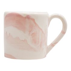 a pink and white coffee mug with a horse on it's side, sitting in front of a white background