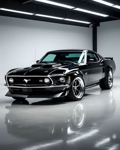 a black muscle car parked in a garage