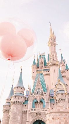 a large castle with two giant balloons attached to it