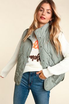 The Irene vest is available in camel and sage colors. It features a high neck with snap button front. It is a sleeveless vest with quilted puffer style. It comes fully lined and has pockets. Fit is extremely generous. Size down if you're layering with thinner tops under it. Green Vest Outfit, Sage Colors, Puffer Style, Neck Snap, Quilted Puffer Vest, Green Vest, Urban Looks, Outerwear Vest, Quilted Vest